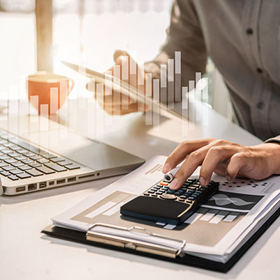 calculator on desk with laptop