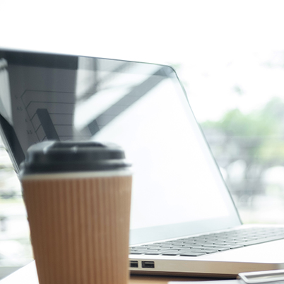 Laptop with coffee on desk