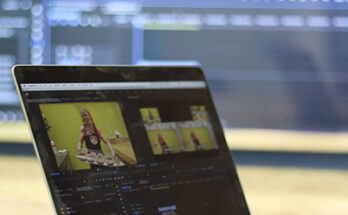 Laptop on table with Premiere in background