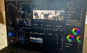 Image of laptop in front of window with Lumetri Color Panel in Premiere pro on screen.
