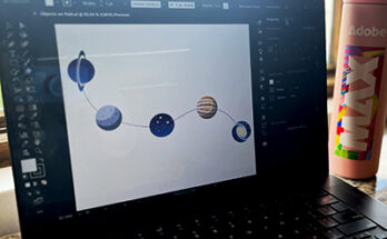Laptop screen with Illustrator on it and a series of planets appearing as objects on a simple path.