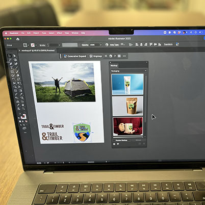 Laptop screen with illustrator open and mockup being used