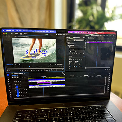Image of laptop screen on table showing object mask in Premiere.
